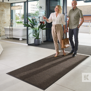Iron-Horse - Black Mink - Couple walking across a mat as they enter a store