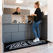 Jet-Print Mat - Reception desk with a large logo mat in front and a customer being served