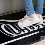 Jet-Print Mat - Close up of a logo mat in front of a reception desk