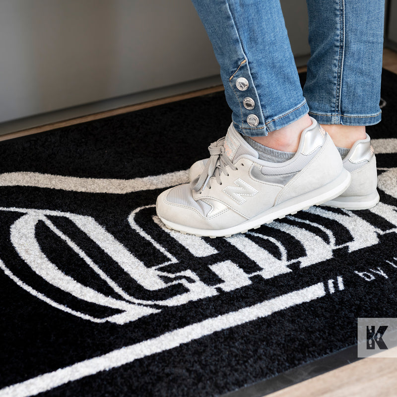 Jet-Print Mat - Close up of a logo mat in front of a reception desk