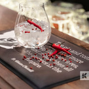 Bar-Mat - A brown mat with a glass of Gin and some chillies