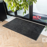 EcoAbsorb Mat - Black mat in front of glass door