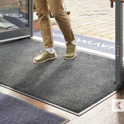 EcoAbsorb Mat - Close up of gentleman's feet as he strolls into a store