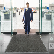 Iron-Horse XL Eco - Ebony - Business man entering a modern office building with a mat on the floor