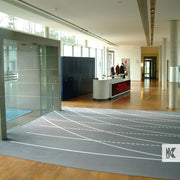 Jet-Print Big Size - Large area printed mat in a modern reception area. Track and field lanes printed on the mat
