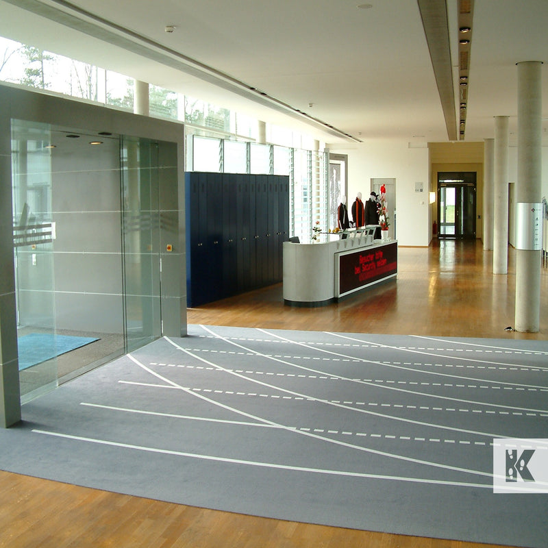 Jet-Print Big Size - Large area printed mat in a modern reception area. Track and field lanes printed on the mat