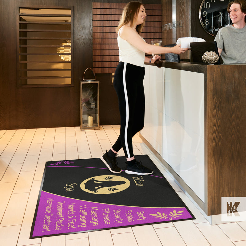 Jet-Print Patio - Lady collects a towel from reception in a Spa while standing on an advertising mat