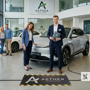 Man holding a brochure in front of an Electric Vehicle in a showroom with a rubber cable mat that is custom branded