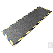 A rectangular industrial anti-slip mat with a textured gray surface and yellow and black hazard striped borders, shown on a white background.
