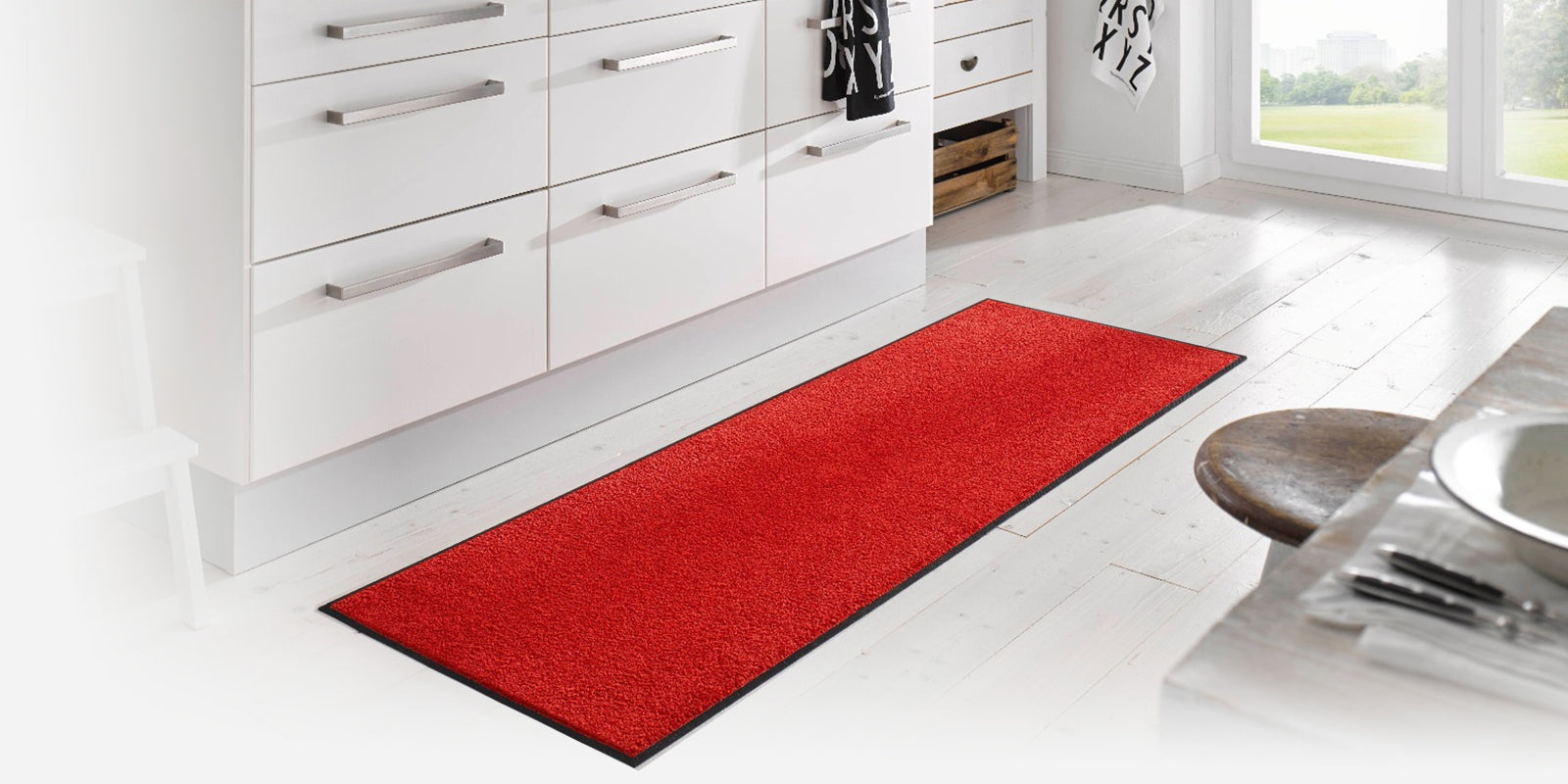 Bright red runner mat in a white room